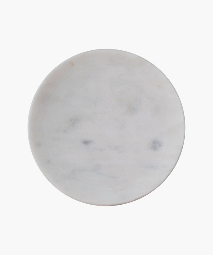 Overhead view of a round white marble soap dish with subtle gray veining. The smooth texture conveys simplicity and elegance.