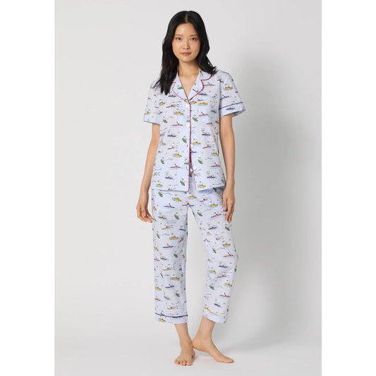 Woman wearing a patterned pajama set on a white background