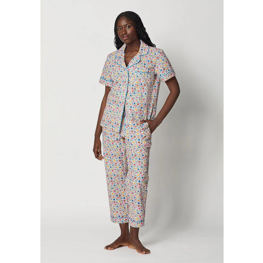 Woman wearing a colorful pajama set on a white background