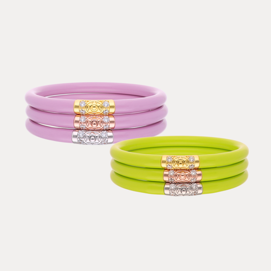 a group of bracelets with gold and pink bands