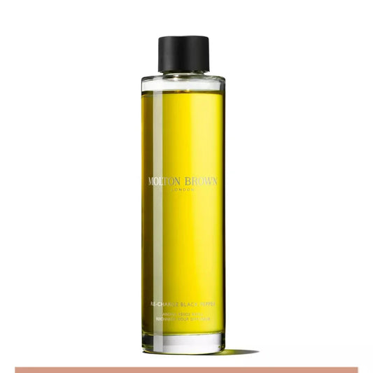 A clear glass bottle with yellow liquid inside, labeled Molton Brown