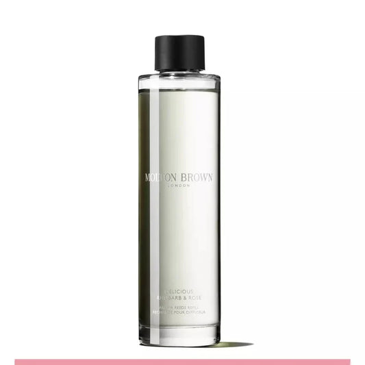 A clear glass bottle with a black cap, labeled 'Molton Brown' and 'Rhubarb & Rose' aroma reeds refill