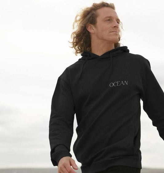 Man wearing a black hoodie with 'OCEAN' logo against a light background