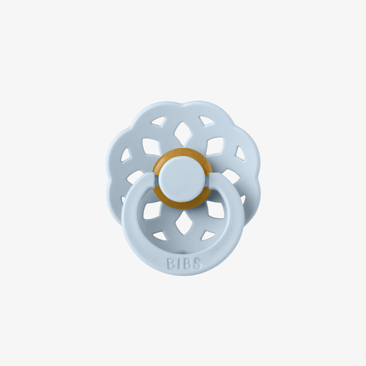 Light blue baby pacifier with gold center on a white background