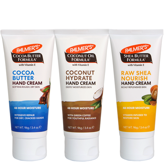 Three tubes of Palmer's hand creams lined up on a white background: Cocoa Butter Hand Cream with blue label, Coconut Hydrate Hand Cream with brown label, and Raw Shea Nourish Hand Cream with yellow label.