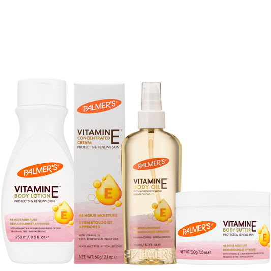 A Palmer's Vitamin E Body Care set featuring a white body lotion bottle, a concentrated vitamin E cream box, a vitamin E body oil spray bottle, and a body butter jar, all on a plain white background.