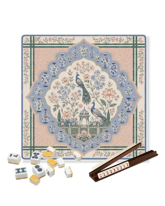 Square game table mat with blue floral bird medallion and green grid border.