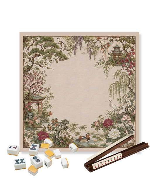 Square mahjong table mat with beige garden scene and scattered tiles on top