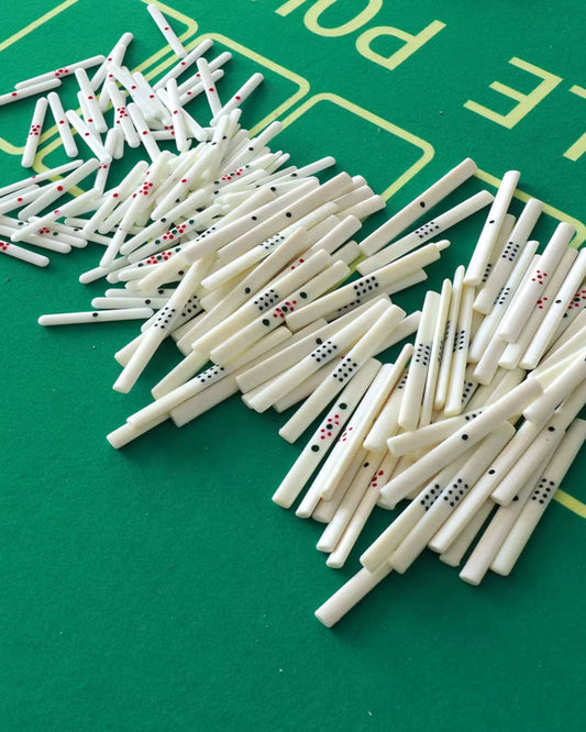 Ivory Mahjong scoring sticks scattered, red/green and black dot patterns
