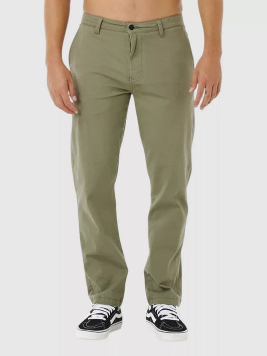 Man wearing rip curl classic surf chino cactus green pants on a white background