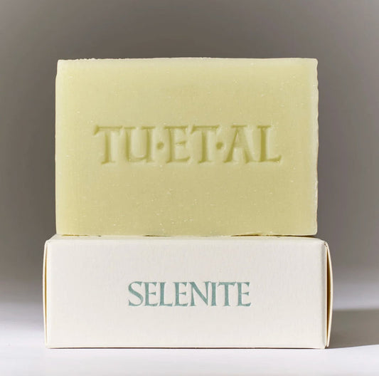 Bar of soap with 'TU•ET•AL' branding on a gray background